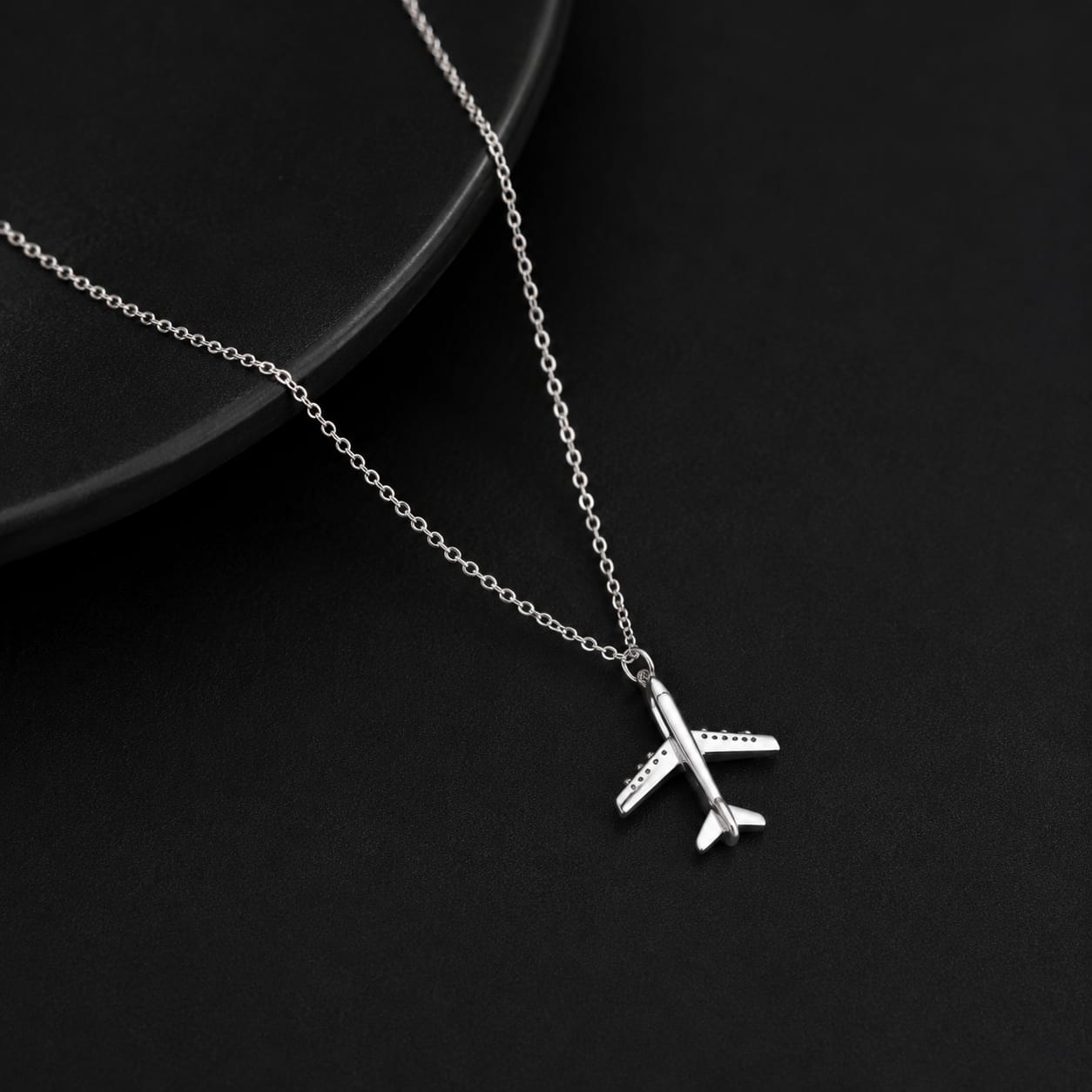 Airplane pendant necklace worn with outfit lightweight travel inspired jewelry for casual fashion styling