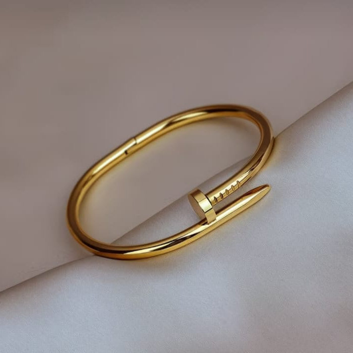 gold nail hand cuff bracelet styled on hand highlighting bold and contemporary fashion jewelry look