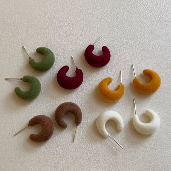 velvet crescent hoop earrings in white olive green mustard orange chocolate brown and maroon displayed together