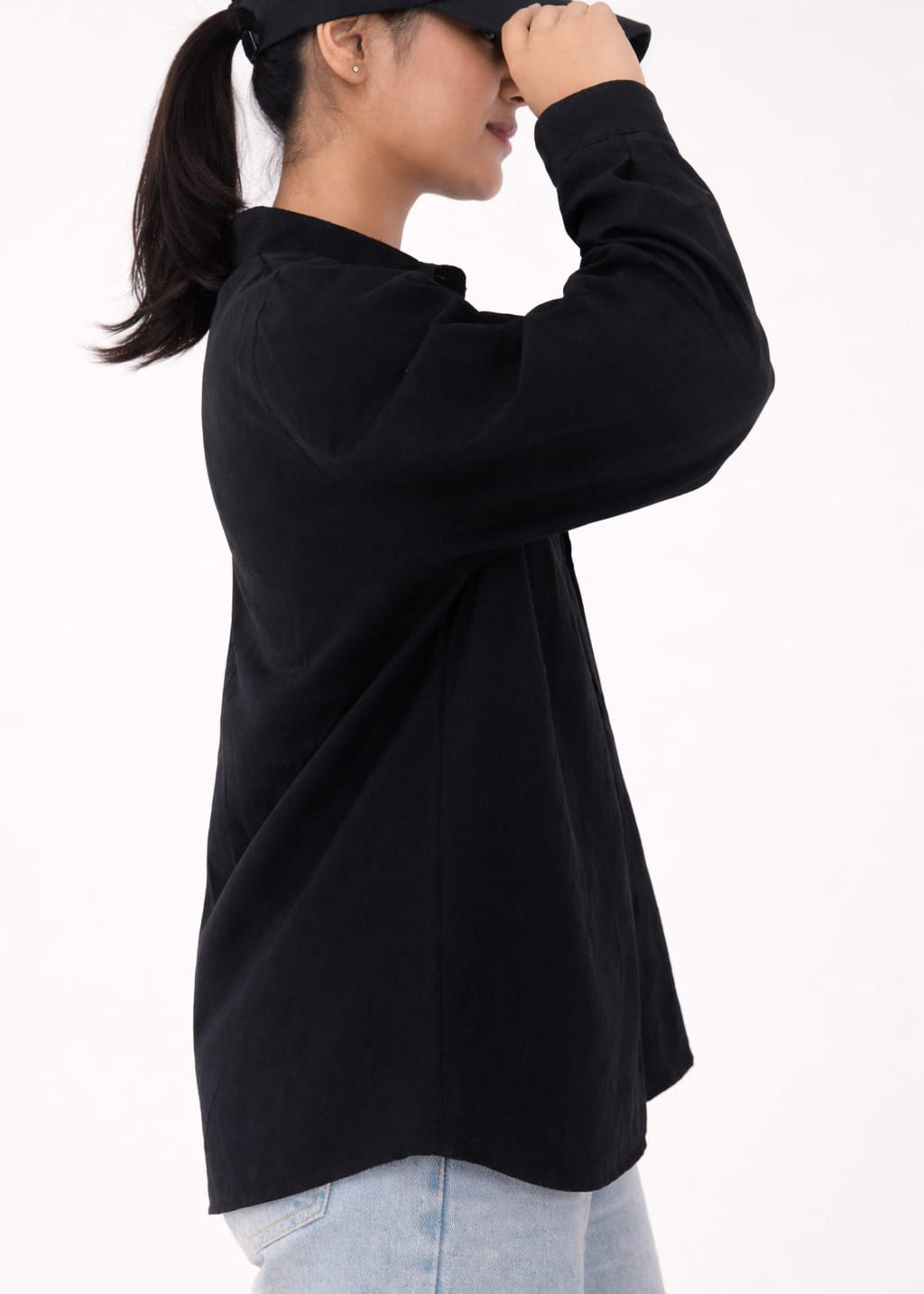 Model wearing black 100% cotton button-down shirt with a clean minimal modern style by NUR, suitable for smart casual and formal wear