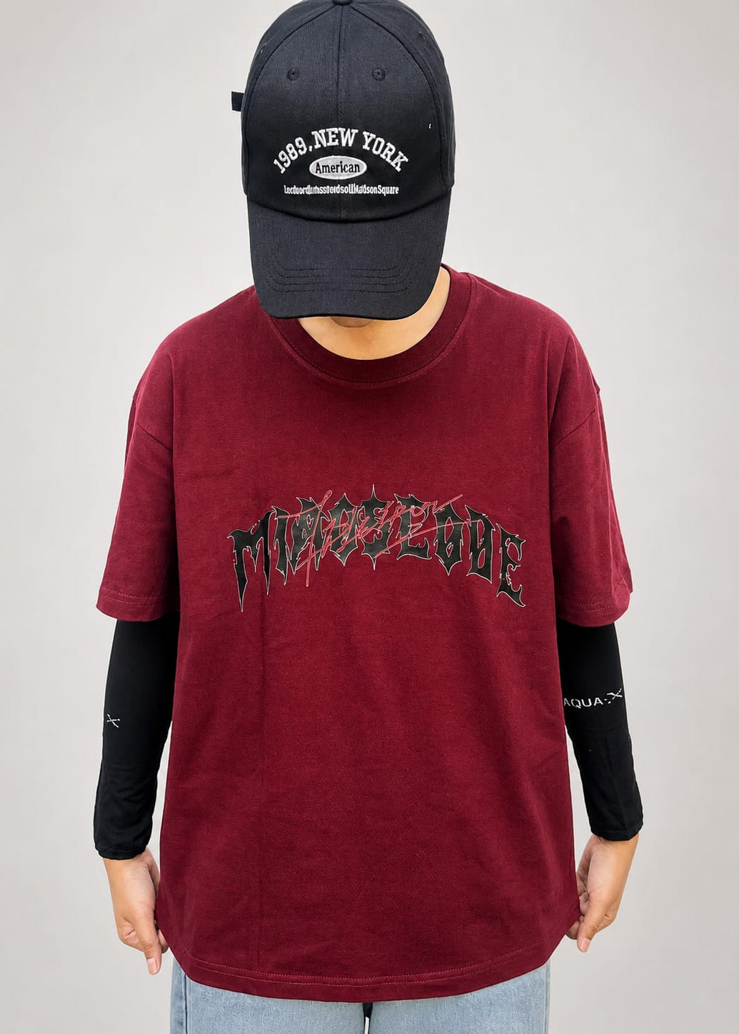 Model wearing maroon cotton t-shirt with a relaxed fit and modern everyday style by NUR