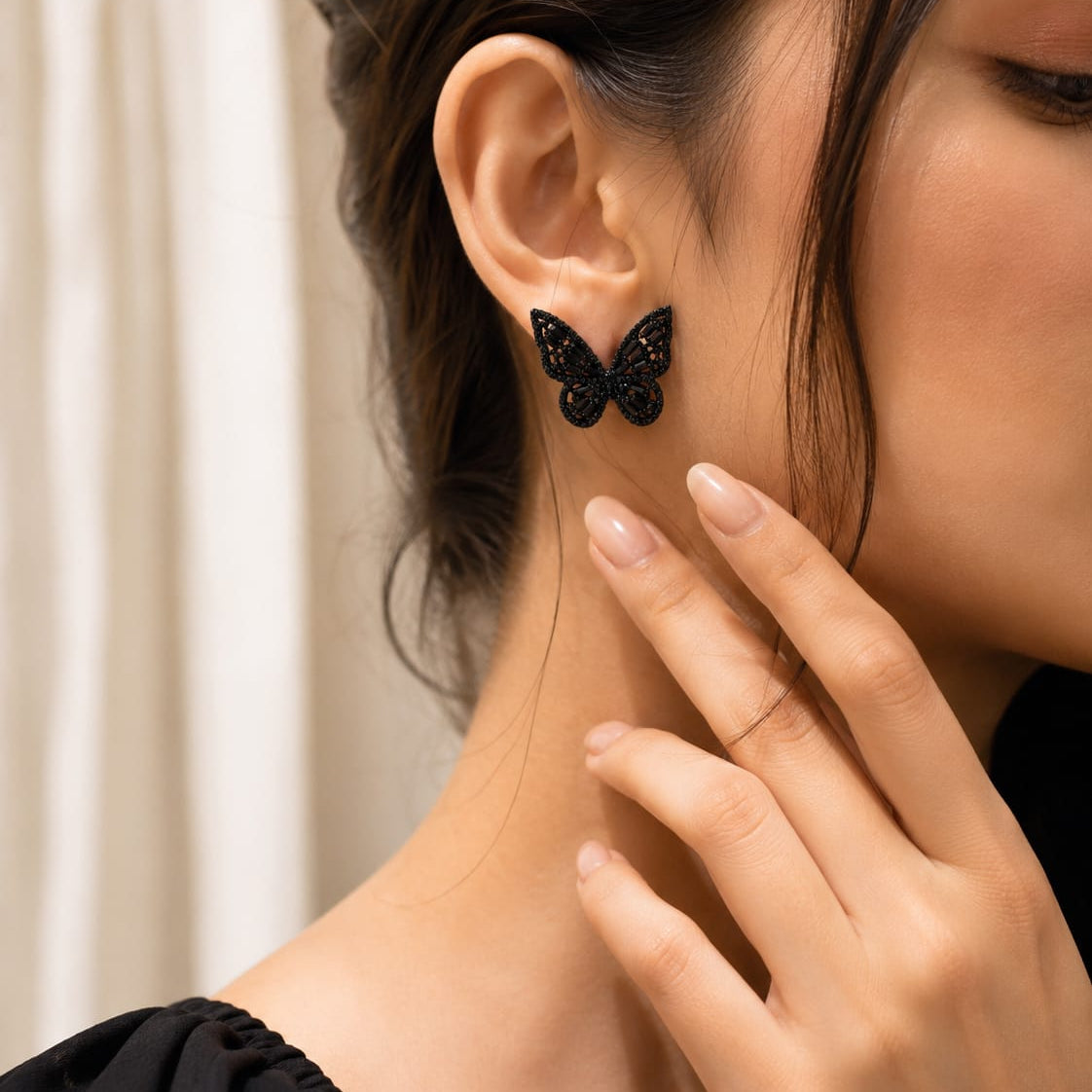 close up of midnight flutter butterfly stud earrings showing detailed crystal wings and elegant shape