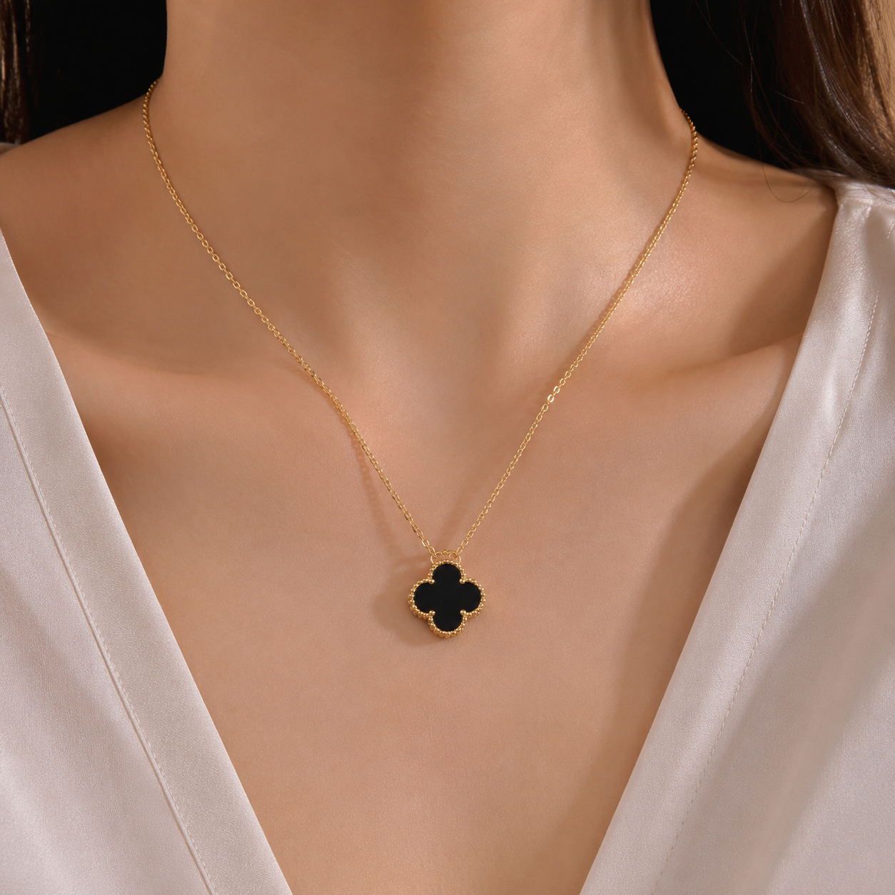 close up of black clover pendant necklace showing smooth finish and fine chain detail