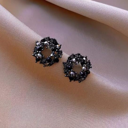 black crystal cluster circle stud earrings styled to highlight bold and modern design