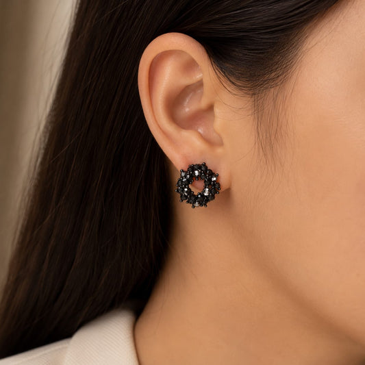 close up of black crystal cluster stud earrings showing round shape and detailed stone setting