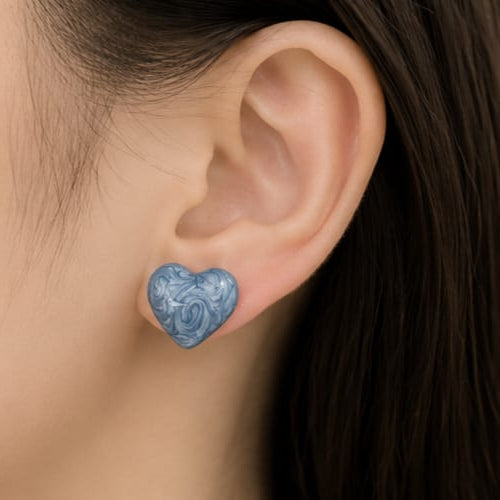 close up of blue marble heart stud earrings showing smooth heart shape with natural marble texture