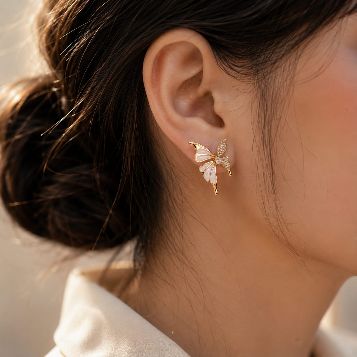 close up of butterfly bloom stud earrings showing intricate butterfly wings with floral crystal accents