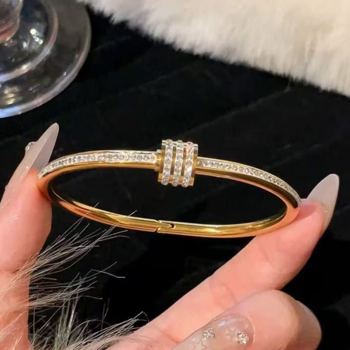 gold crystal accent bangle styled on wrist highlighting sleek and modern design