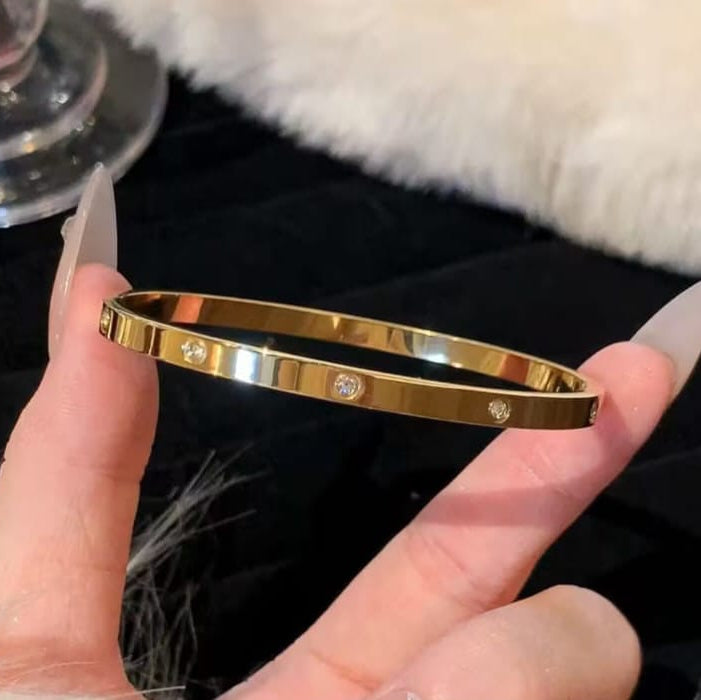 gold crystal bangle styled on wrist highlighting sleek design and modern luxury look
