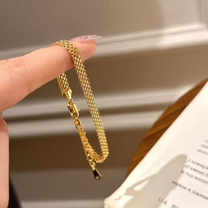 gold mesh chain bracelet styled on wrist highlighting flexible design and modern aesthetic
