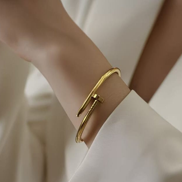 close up of gold nail hand cuff bracelet showing smooth polished finish and unique wrap design