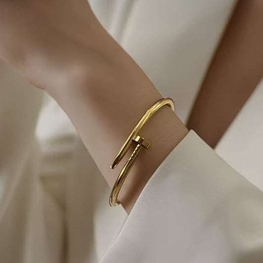 close up of gold nail hand cuff bracelet showing smooth polished finish and unique wrap design