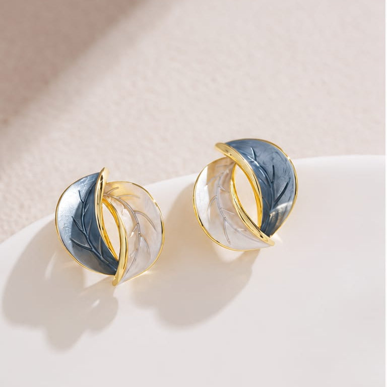 leaf stud earrings styled to highlight simple botanical shape with modern elegant look