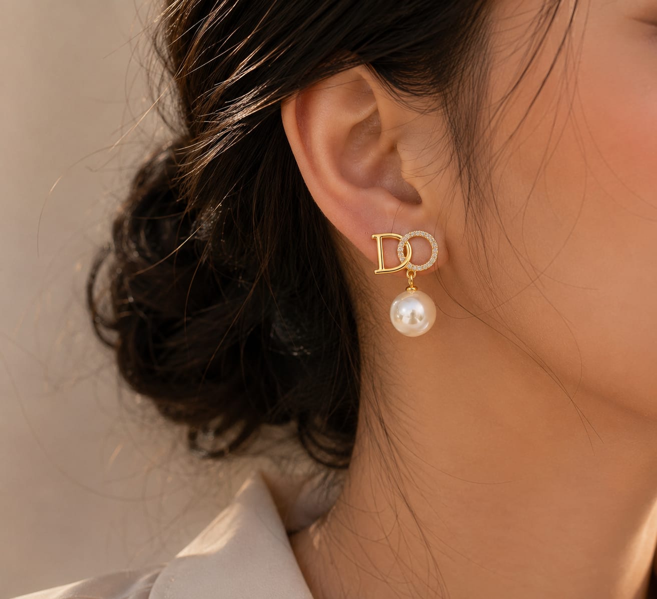 close up of crystal pearl monogram drop earrings showing intricate lettering with crystal and pearl accents