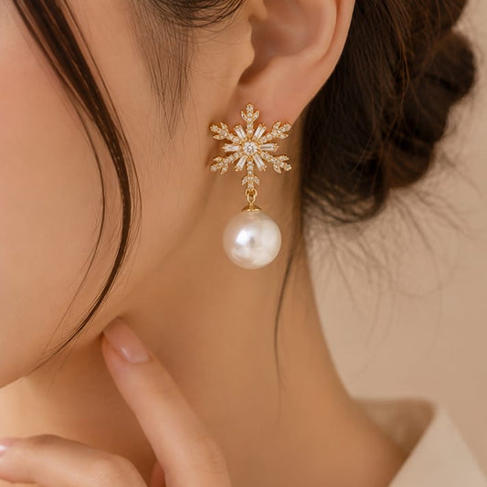 close up of snowflake pearl earrings showing intricate snowflake pattern with pearl and crystal accents