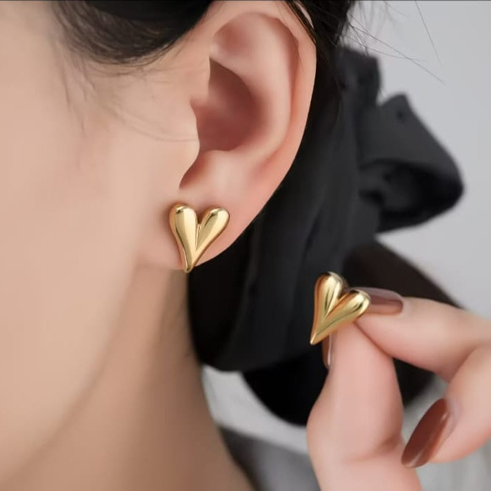 close up of puffy heart stud earrings showing plump heart shape with polished surface