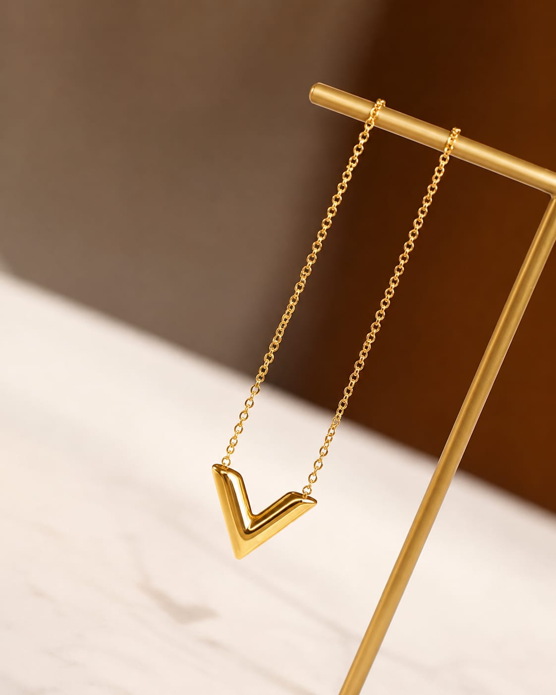 V pendant necklace worn by model minimal aesthetic outfit elegant styling look