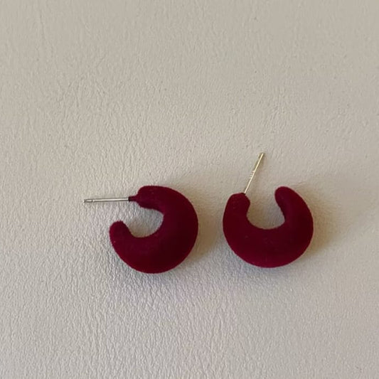 maroon velvet crescent hoop earrings with deep red tone and bold curved silhouette