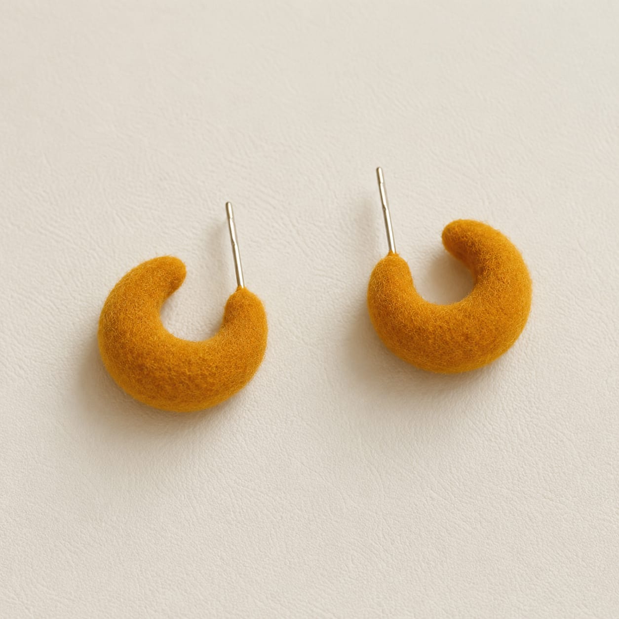 mustard orange velvet crescent hoop earrings with vibrant curved design and modern style