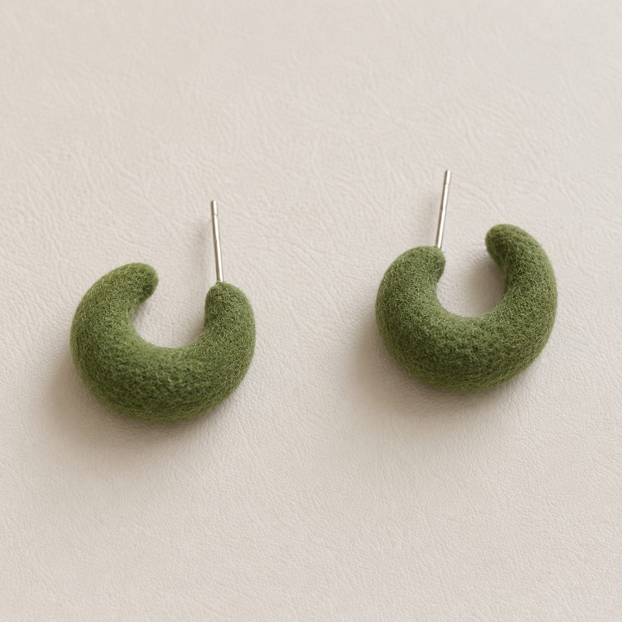 olive green velvet crescent hoop earrings with bold curved silhouette and earthy tone