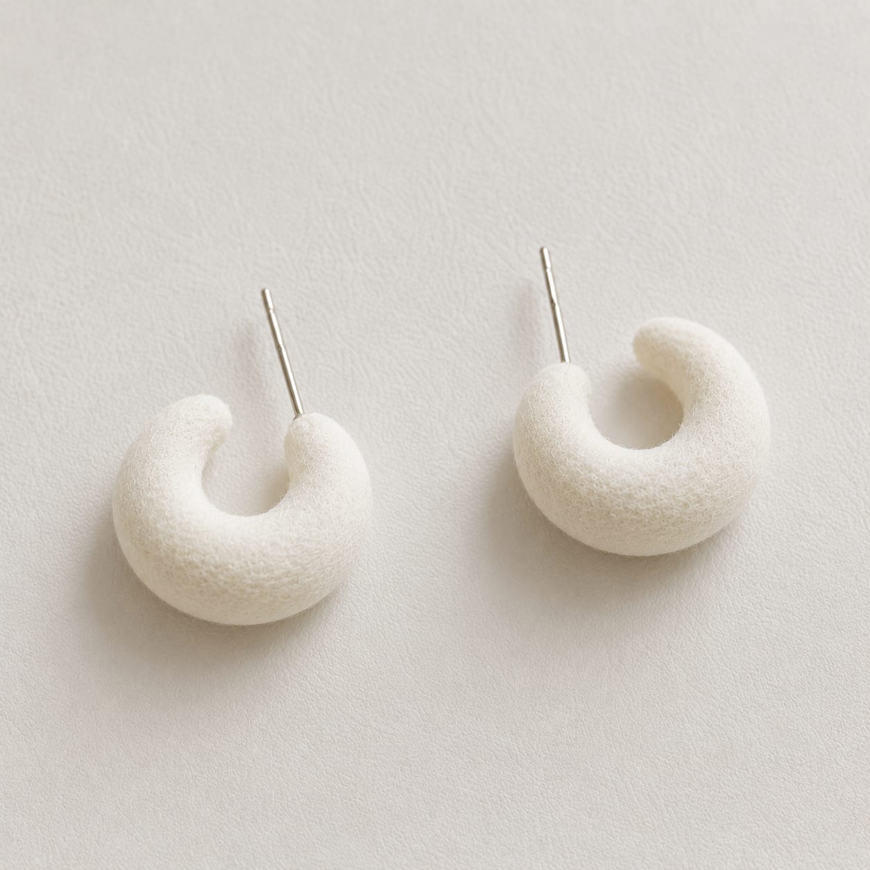 white velvet crescent hoop earrings with smooth curved moon shape and clean minimalist design