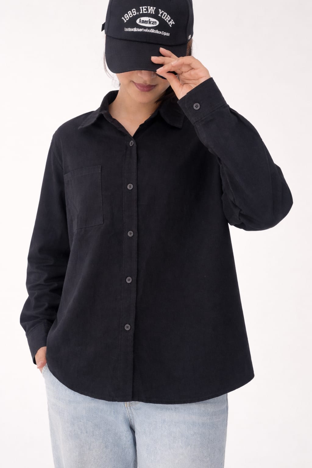 Model wearing black 100% cotton button-down shirt with a clean minimal modern style by NUR, suitable for smart casual and formal wear