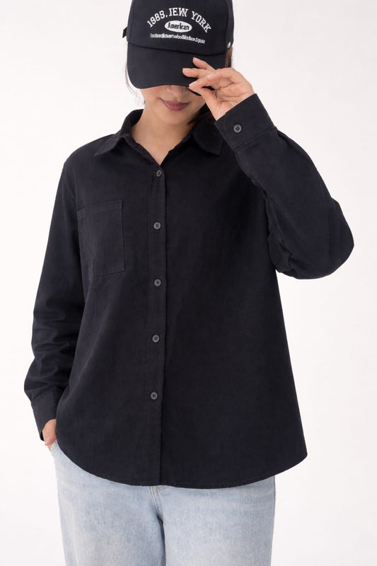 Model wearing black 100% cotton button-down shirt with a clean minimal modern style by NUR, suitable for smart casual and formal wear