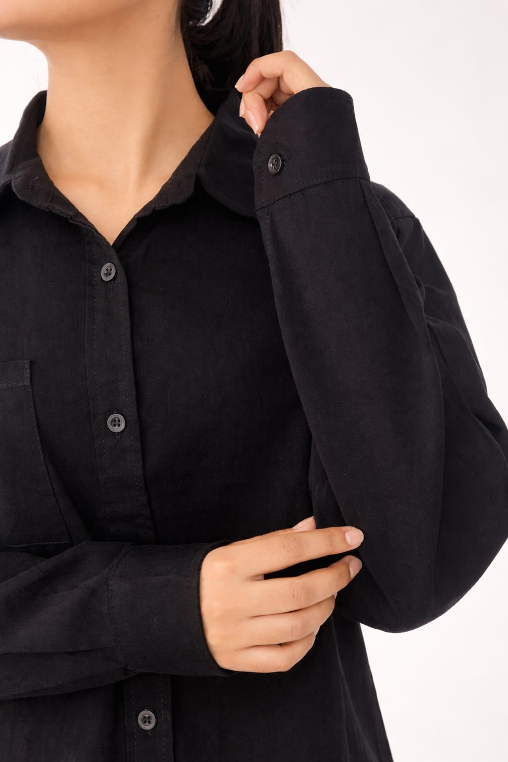 Model wearing black 100% cotton button-down shirt with a clean minimal modern style by NUR, suitable for smart casual and formal wear