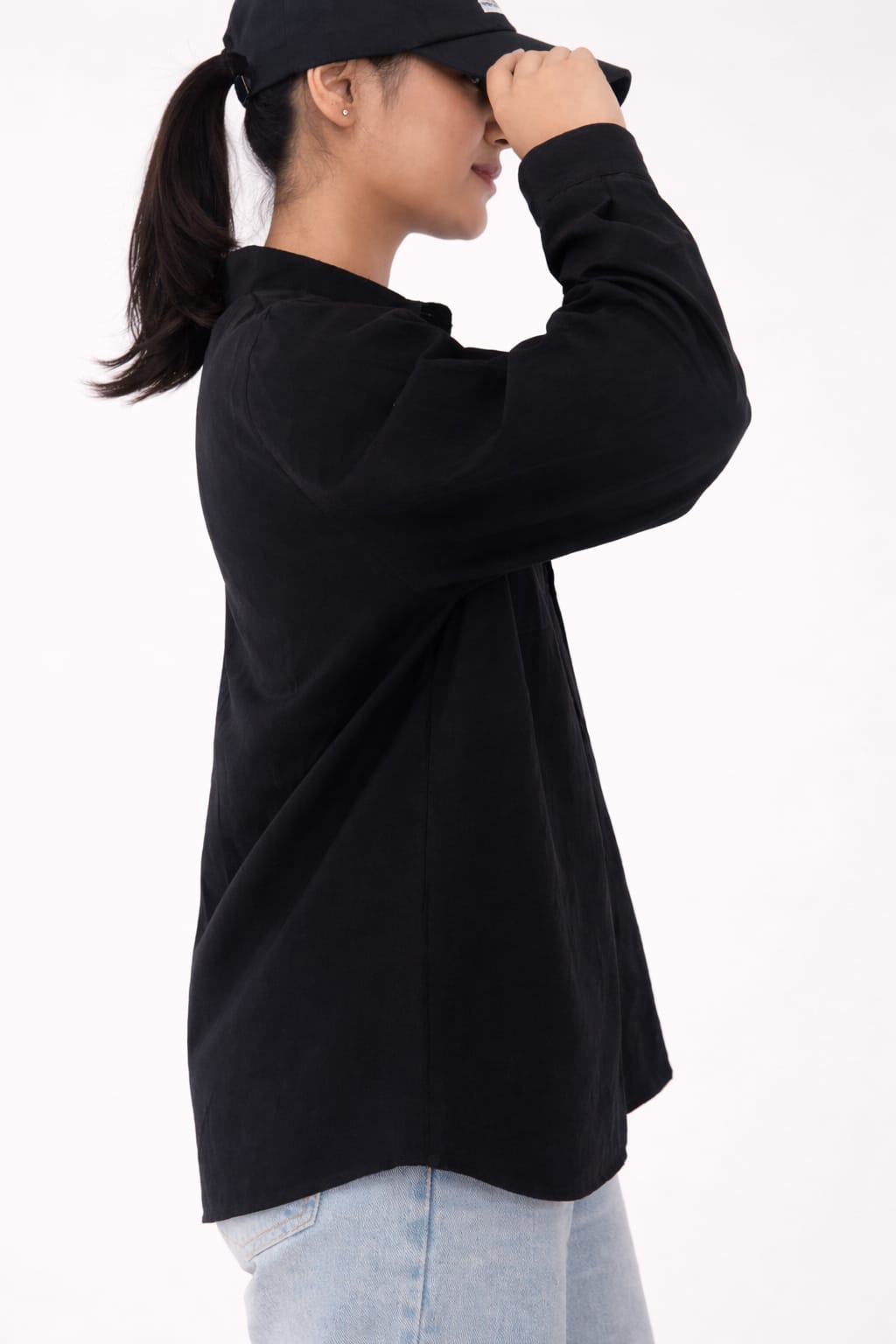 Model wearing black 100% cotton button-down shirt with a clean minimal modern style by NUR, suitable for smart casual and formal wear