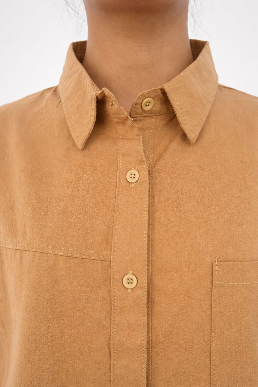 Model wearing brown 100% cotton button-down shirt with a clean minimal style by NUR, perfect for smart casual and everyday wear