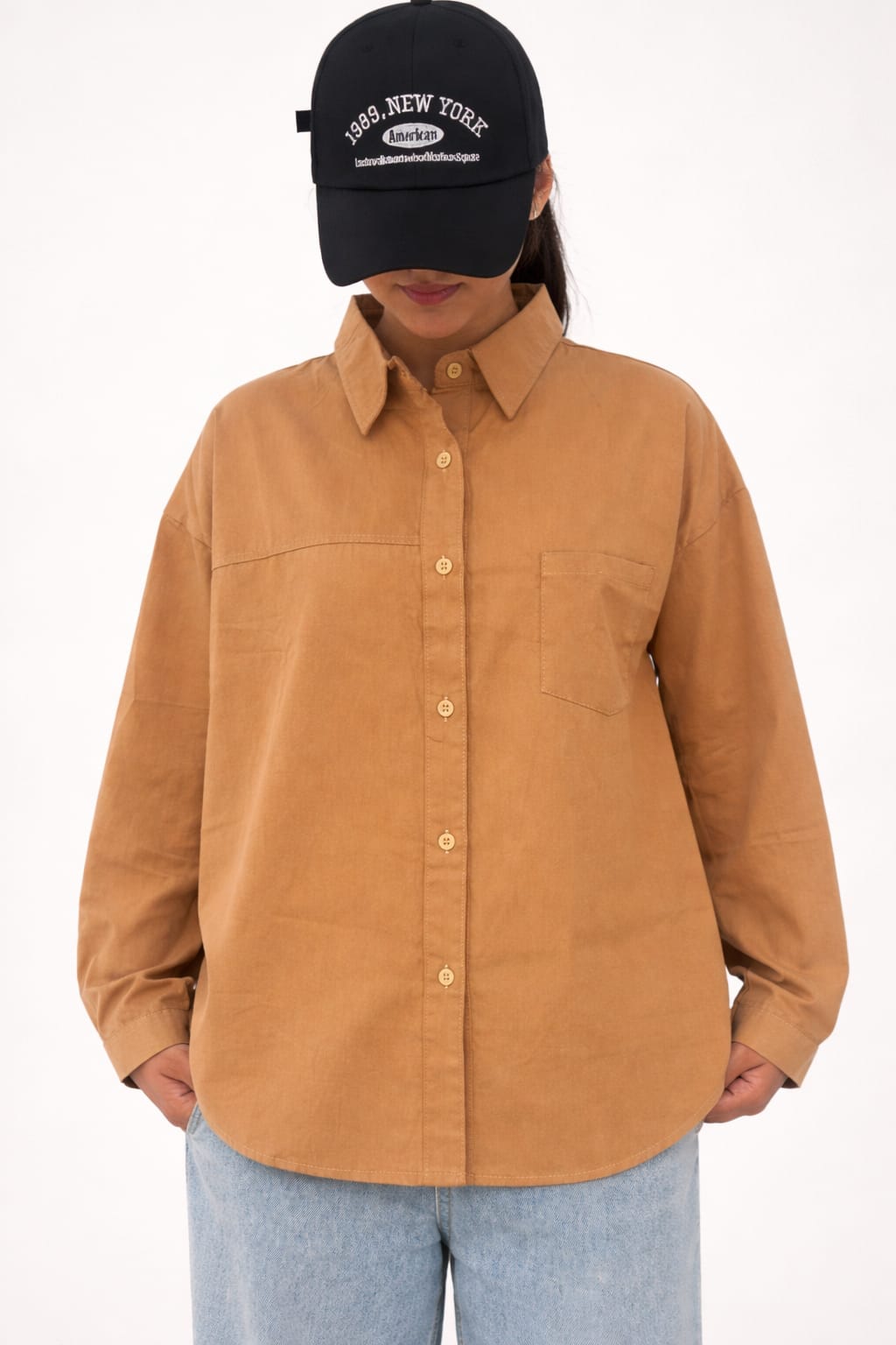 Model wearing brown 100% cotton button-down shirt with a clean minimal style by NUR, perfect for smart casual and everyday wear