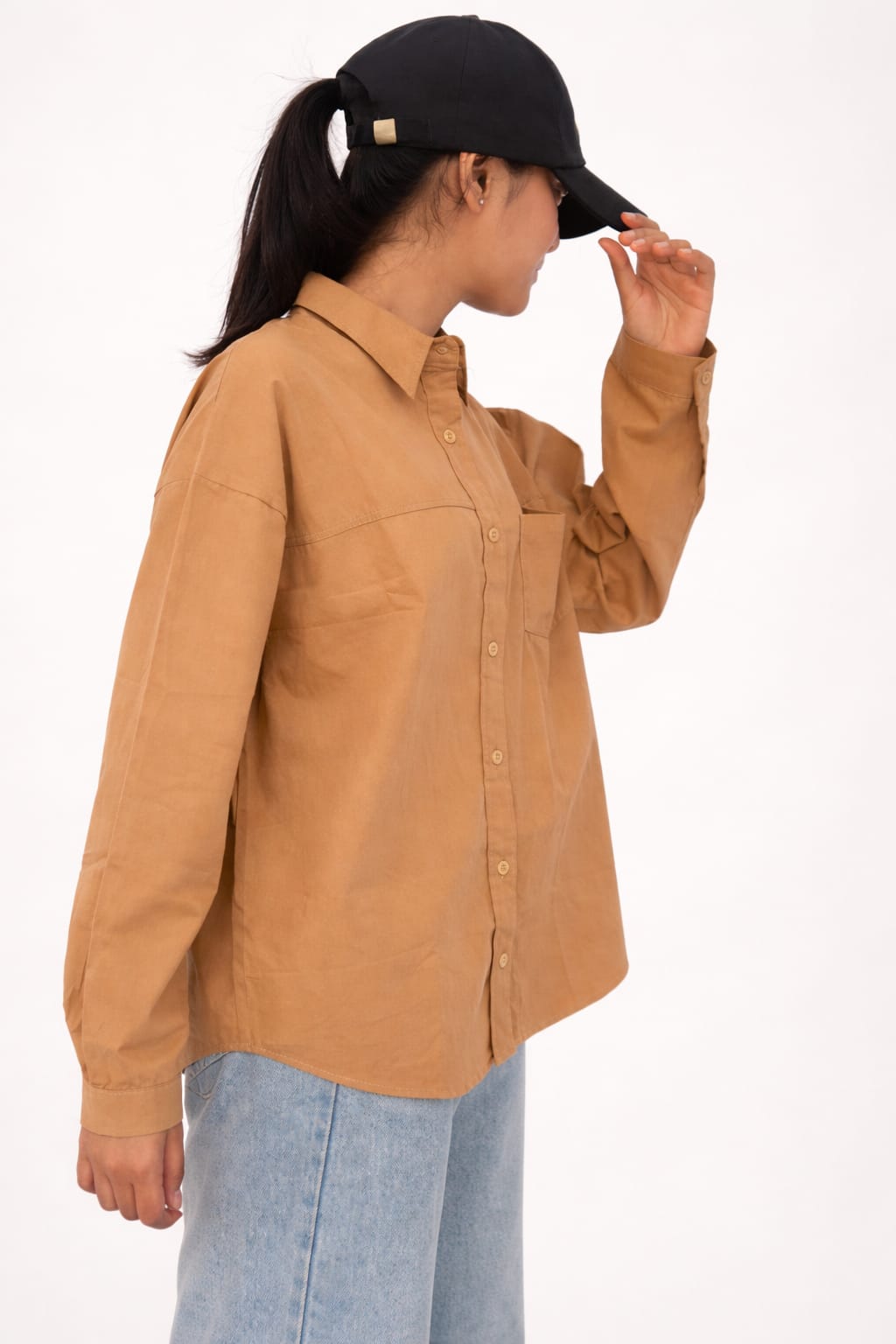Model wearing brown 100% cotton button-down shirt with a clean minimal style by NUR, perfect for smart casual and everyday wear