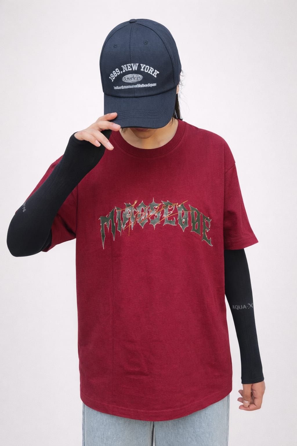 Model wearing maroon cotton t-shirt with a relaxed fit and modern everyday style by NUR