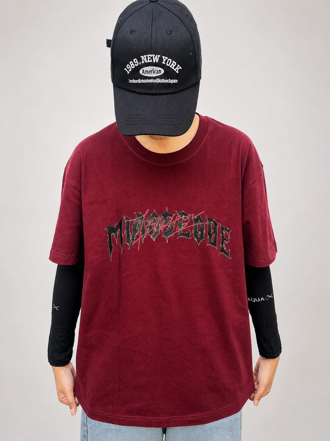 Model wearing maroon cotton t-shirt with a relaxed fit and modern everyday style by NUR