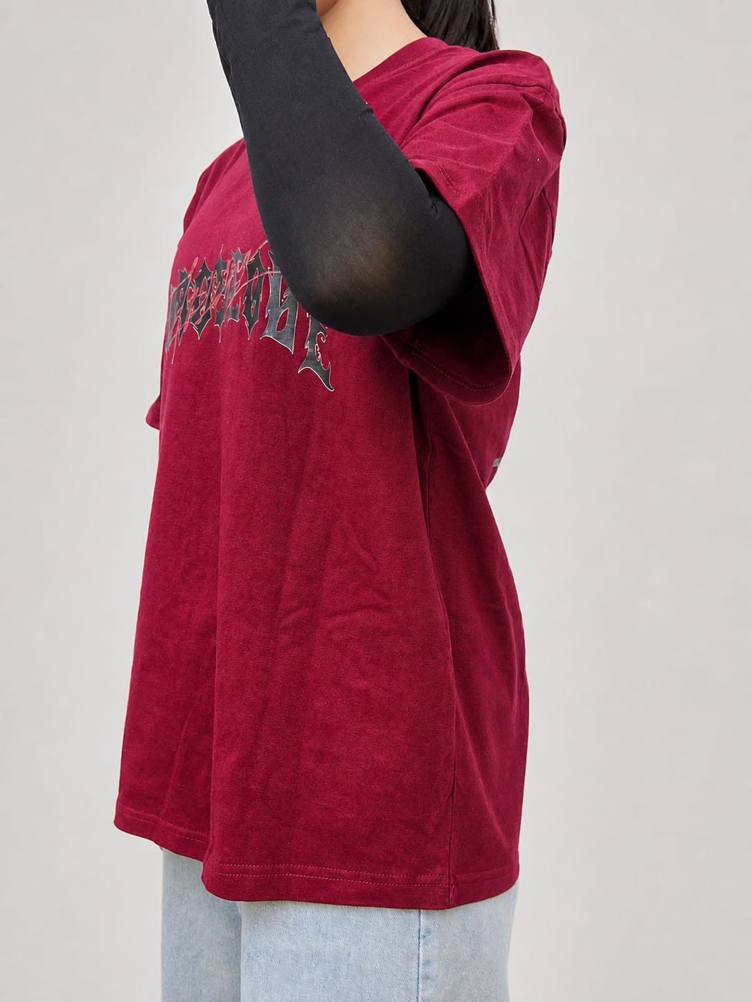 Model wearing maroon cotton t-shirt with a relaxed fit and modern everyday style by NUR