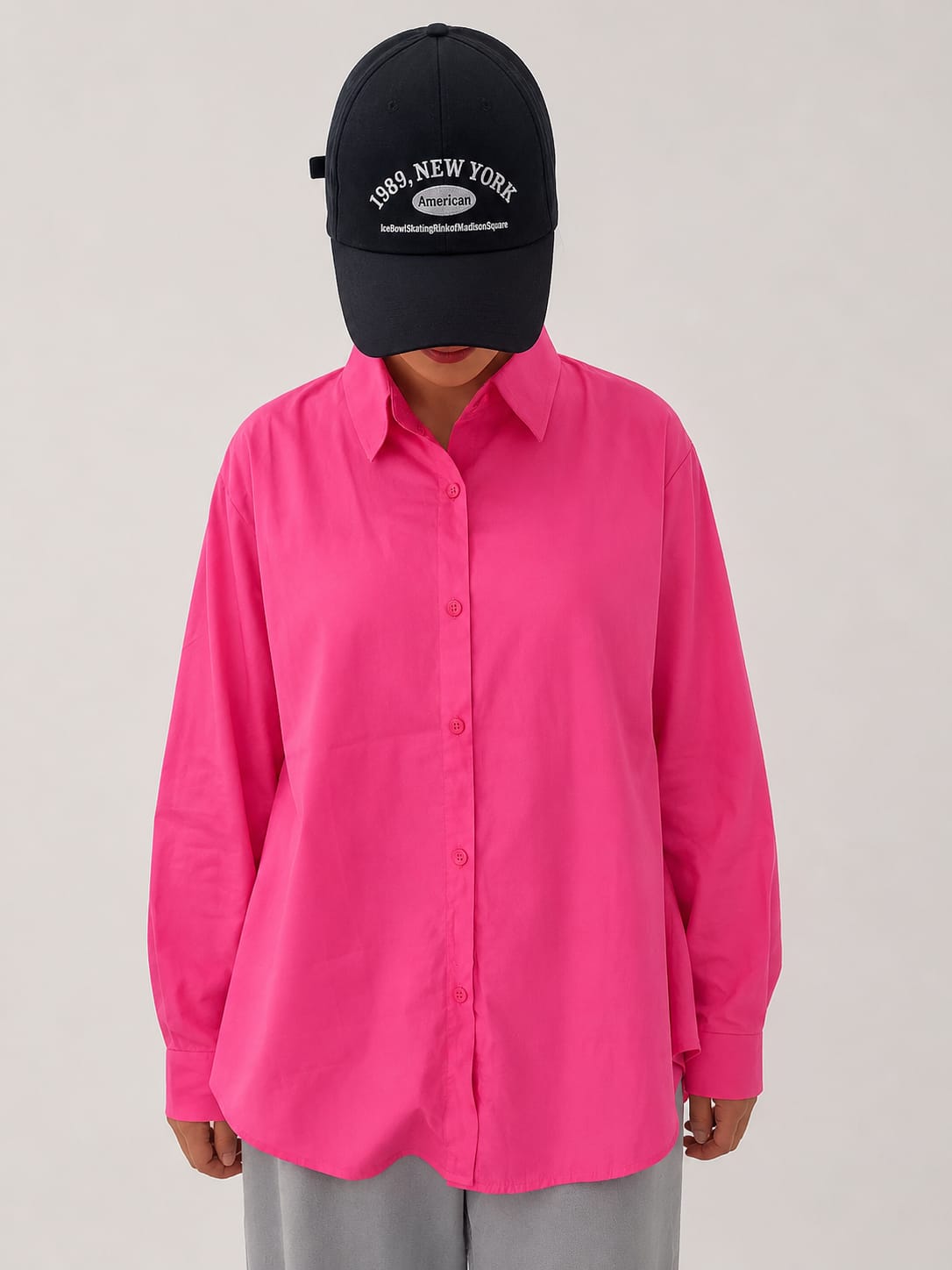 Model wearing soft pink 100% cotton button-down shirt with a clean minimal style by NUR