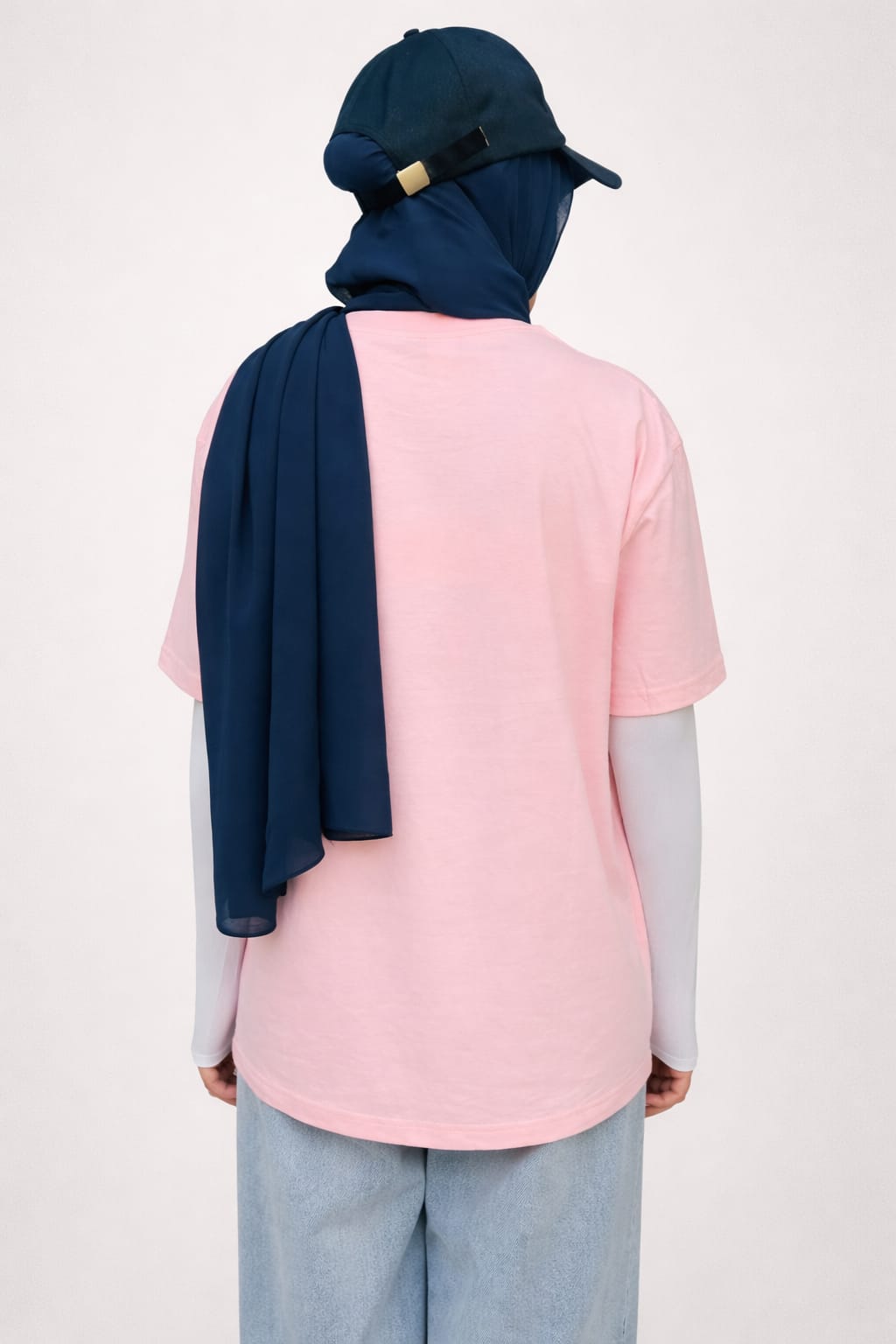 Model wearing pink graphic t-shirt with “Whats Up Dudes” print in a relaxed casual streetwear style by NUR