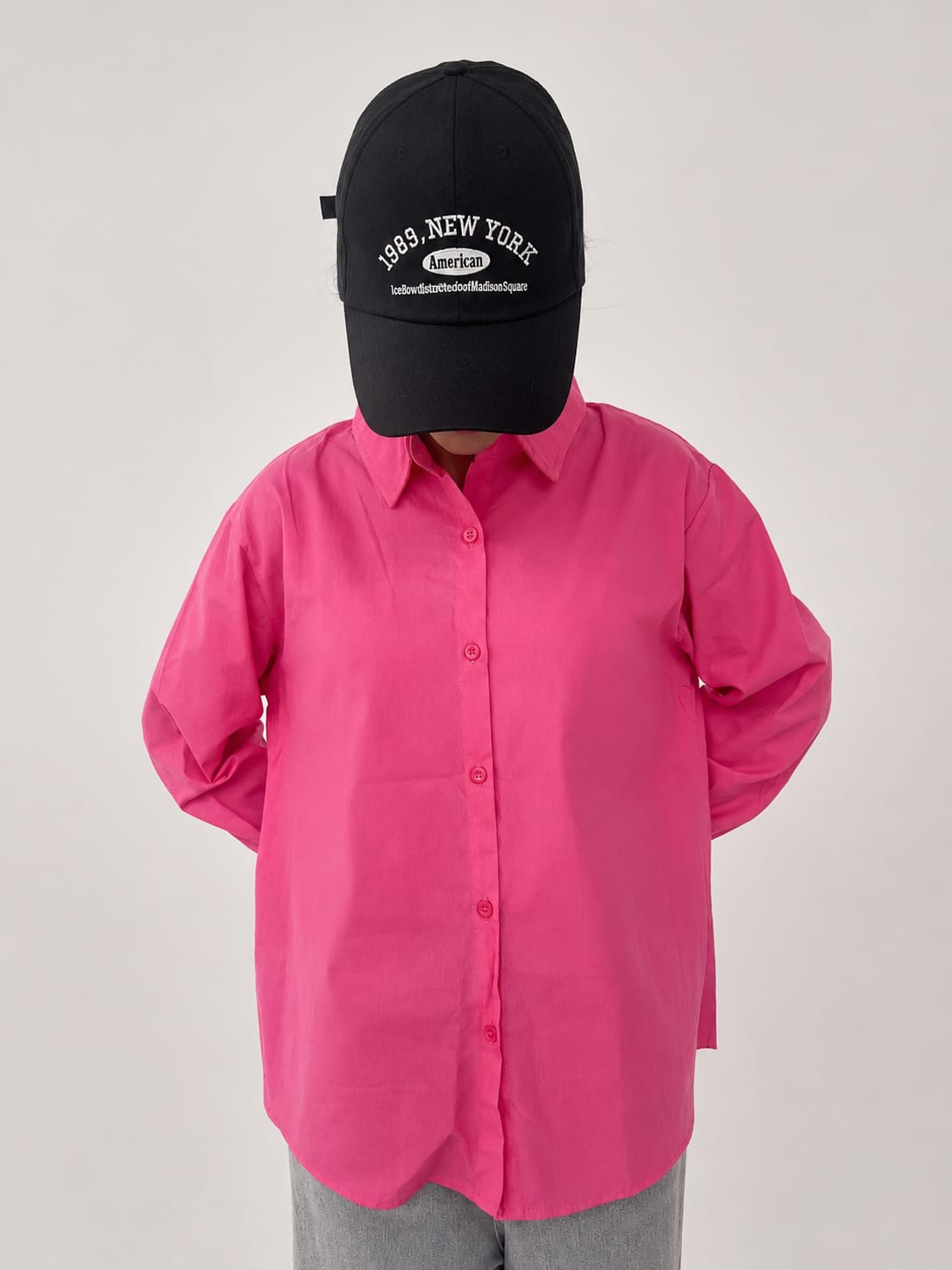 Model wearing soft pink 100% cotton button-down shirt with a clean minimal style by NUR