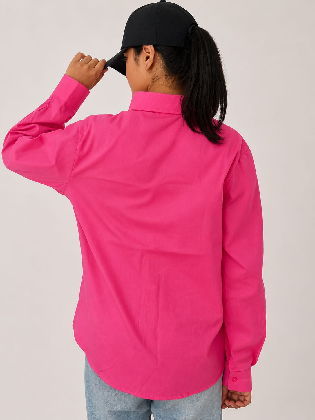 Model wearing soft pink 100% cotton button-down shirt with a clean minimal style by NUR
